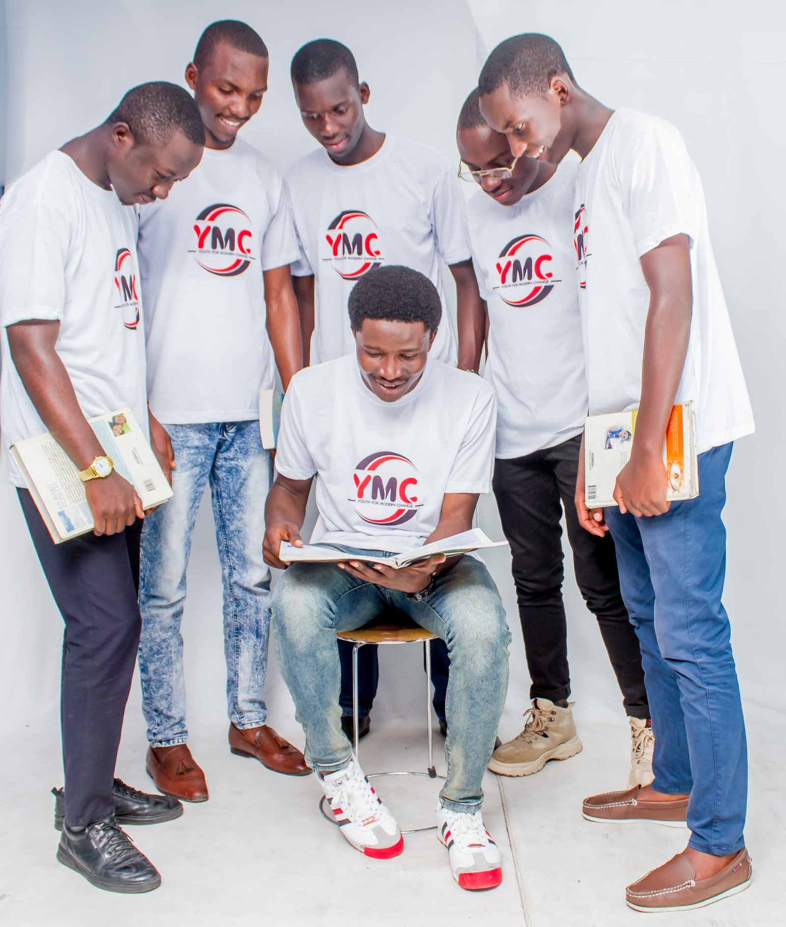 The Youth for Modern Change group in white YMC t-shirts