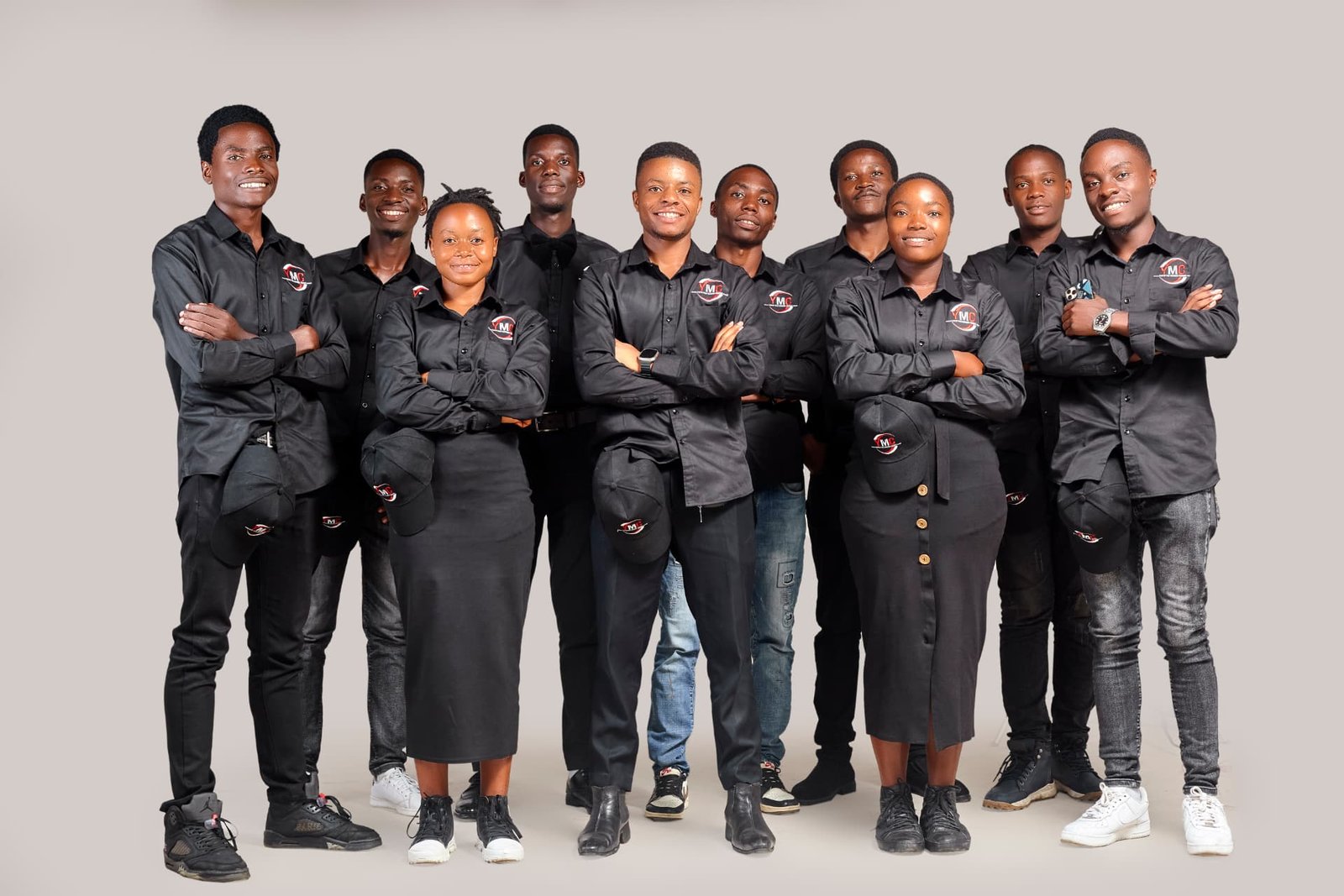 The Youth for Modern Change team in black YMC uniforms
